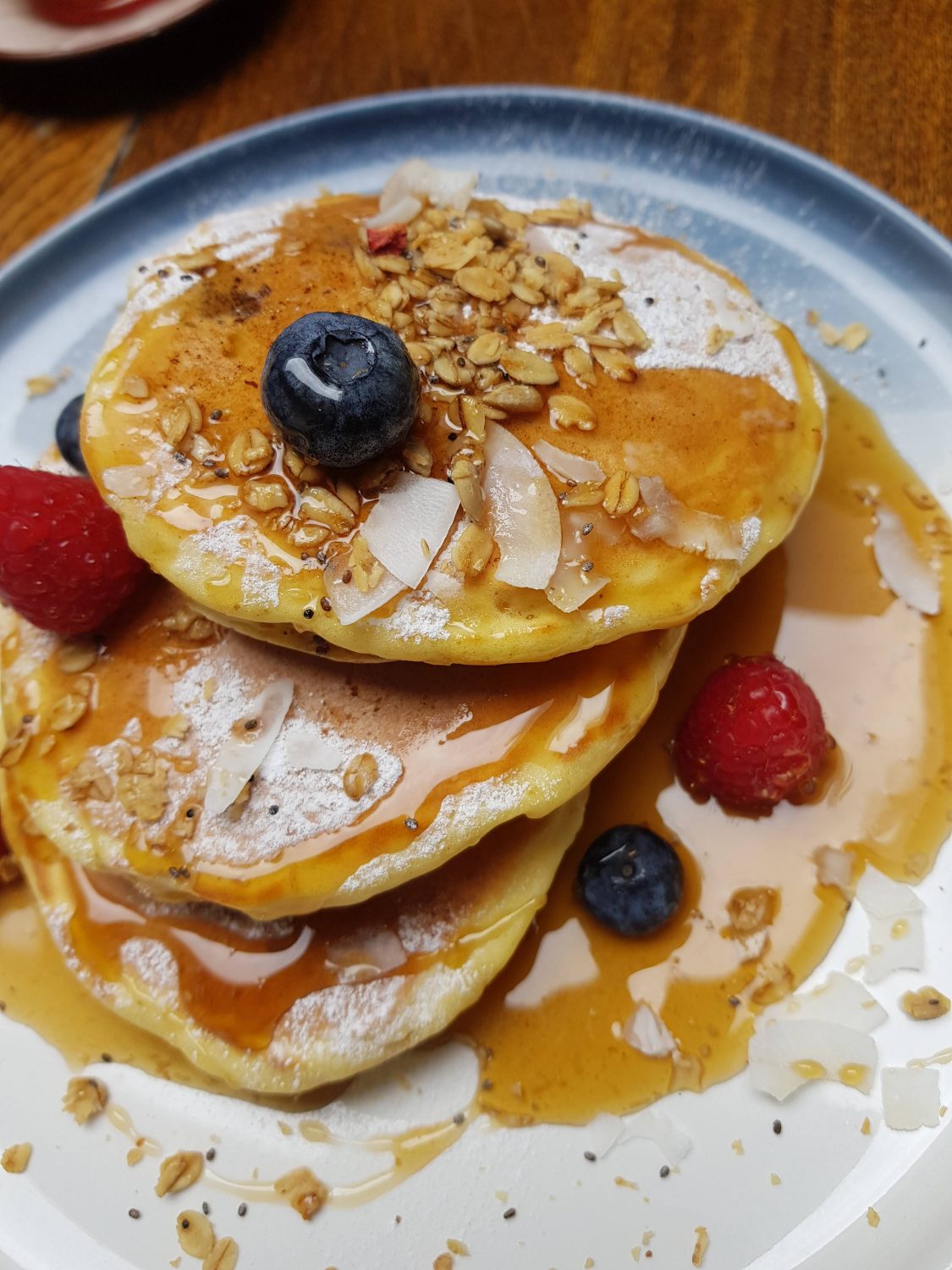 Buttermilk Pancakes with berries, coconut and maple syrup